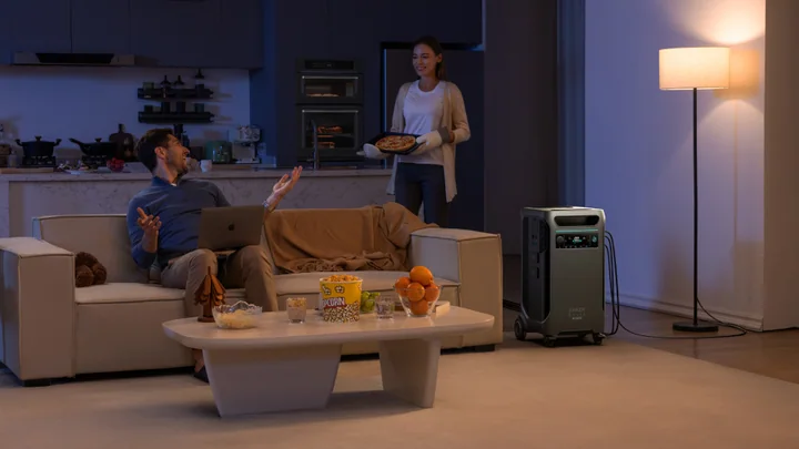 Anker SOLIX F3800 Plus beside a sofa in a living room at night.